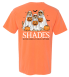 Orange t-shirt with Halloween-themed design of dogs in ghost costumes and pumpkins, featuring the brand 'SHADES'.