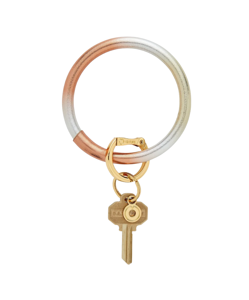 Keychain with a gold key and two-tone rubber band on a white background