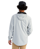 Man wearing a light gray HUK jacket and cap with a logo on a white background