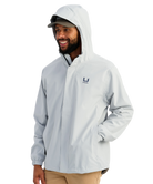 Man wearing a light gray HUK jacket and cap with a logo on a white background