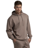Man wearing a brown hoodie and jogger pants on a white background