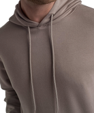Close-up of a brown hoodie with a neutral background