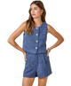 Woman wearing a blue sleeveless top and shorts set on a white background