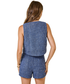 Woman wearing a blue checkered outfit on a white background