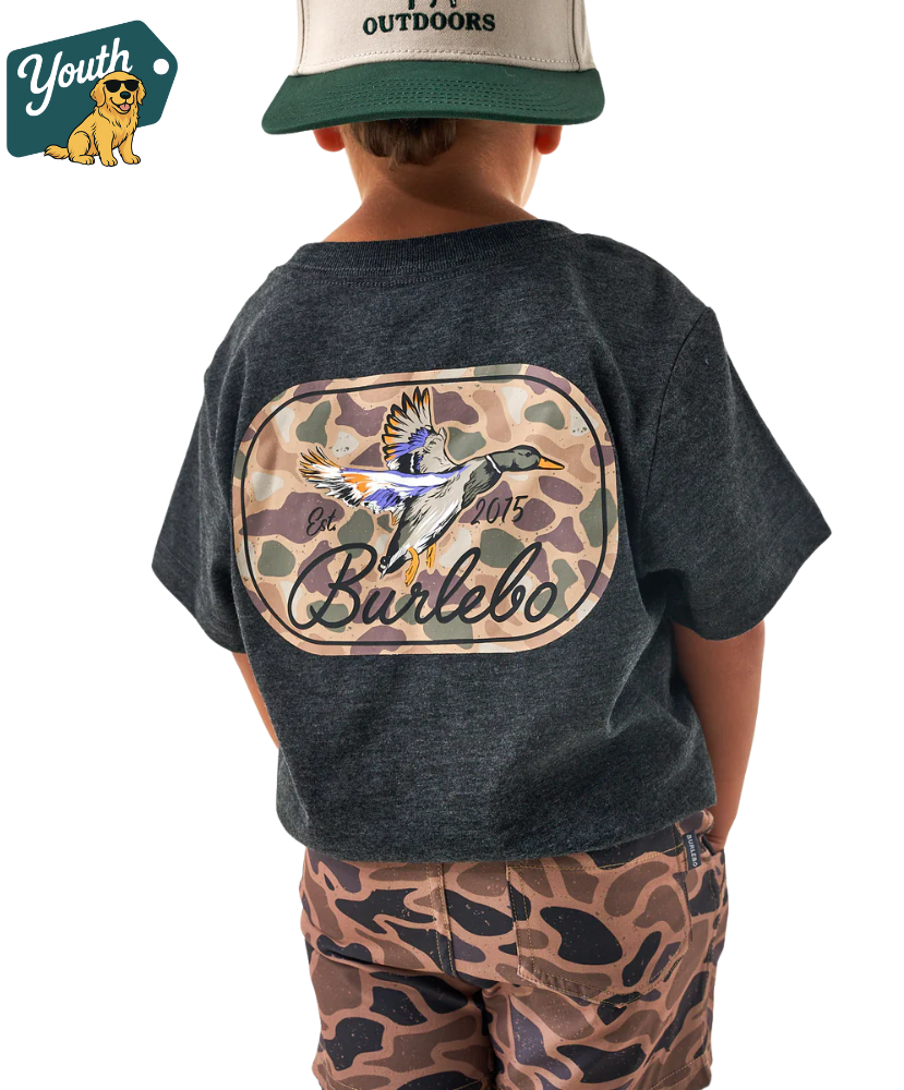 Child wearing a dark gray t-shirt with a colorful duck graphic and text, standing against a white background.