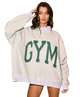Woman wearing a beige sweatshirt with 'GYM' printed in green on a white background