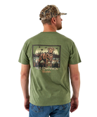 Man wearing a green t-shirt with a dog graphic and 'Field Companion' text, standing against a white background.