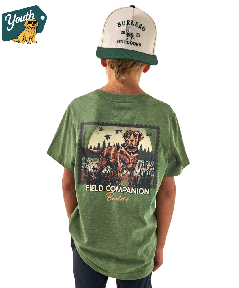 Child wearing a green t-shirt with a dog graphic and text, standing against a white background.