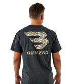 Man wearing a dark gray t-shirt with a camouflage logo and 'BURLEBO' text on the back.