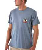 Man wearing a blue t-shirt with a logo on the chest pocket against a white background