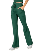 Woman wearing a green tank and pants athleisure set outfit on a white background