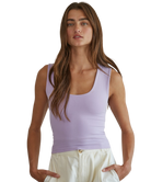 Woman wearing a purple tank top on a white background