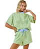 Woman wearing a green and white striped outfit on a white background