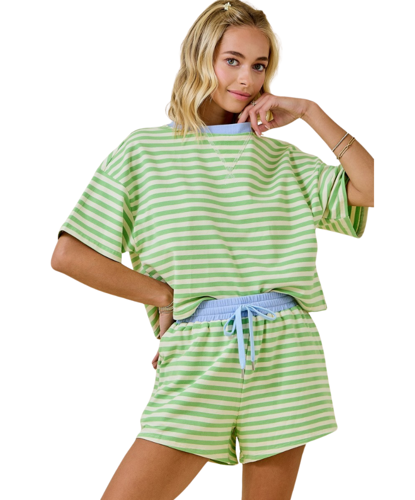 Woman wearing a green and white striped outfit on a white background
