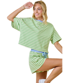 Woman wearing a green and white striped outfit on a white background