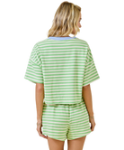 Woman wearing a green and white striped outfit on a white background