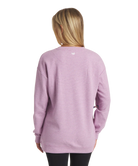 Person wearing a purple sweatshirt with a visible brand logo on the back.