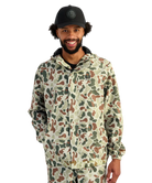 Man wearing a camouflage jacket and cap on a white background