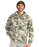 Man wearing a camouflage HUK jacket and beanie on a white background