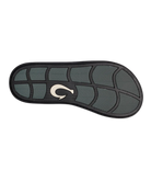 Black sandal sole with a Olukai logo on a white background