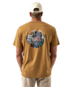 Man wearing a light brown t-shirt with a colorful dog and duck design on the back, standing against a white background.