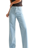 Woman wearring light denim pants with a high rise and wide leg