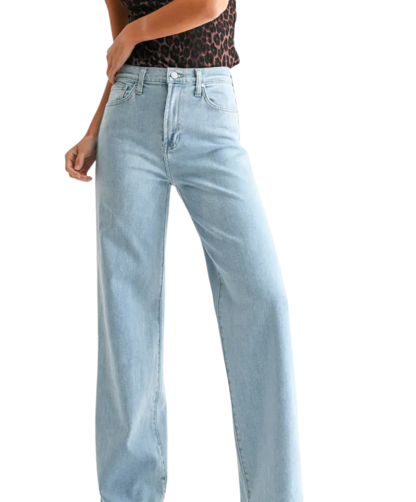 Woman wearring light denim pants with a high rise and wide leg