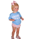 Child wearing a blue shirt with 'Orange Beach' text and pink shorts on a white background