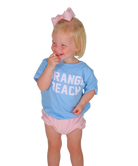 Child wearing a blue shirt with 'Orange Beach' text and pink shorts on a white background