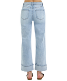 Light blue jeans worn by a person on a white background
