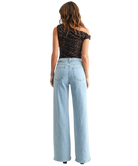 Woman wearring light denim pants with a high rise and wide leg