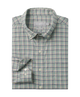 Folded plaid shirt with a visible brand label on a white background