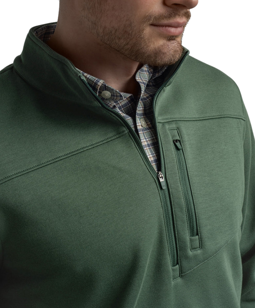 Green pullover with a plaid shirt underneath on a white background