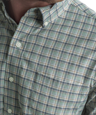 Close-up of a green plaid shirt with buttons