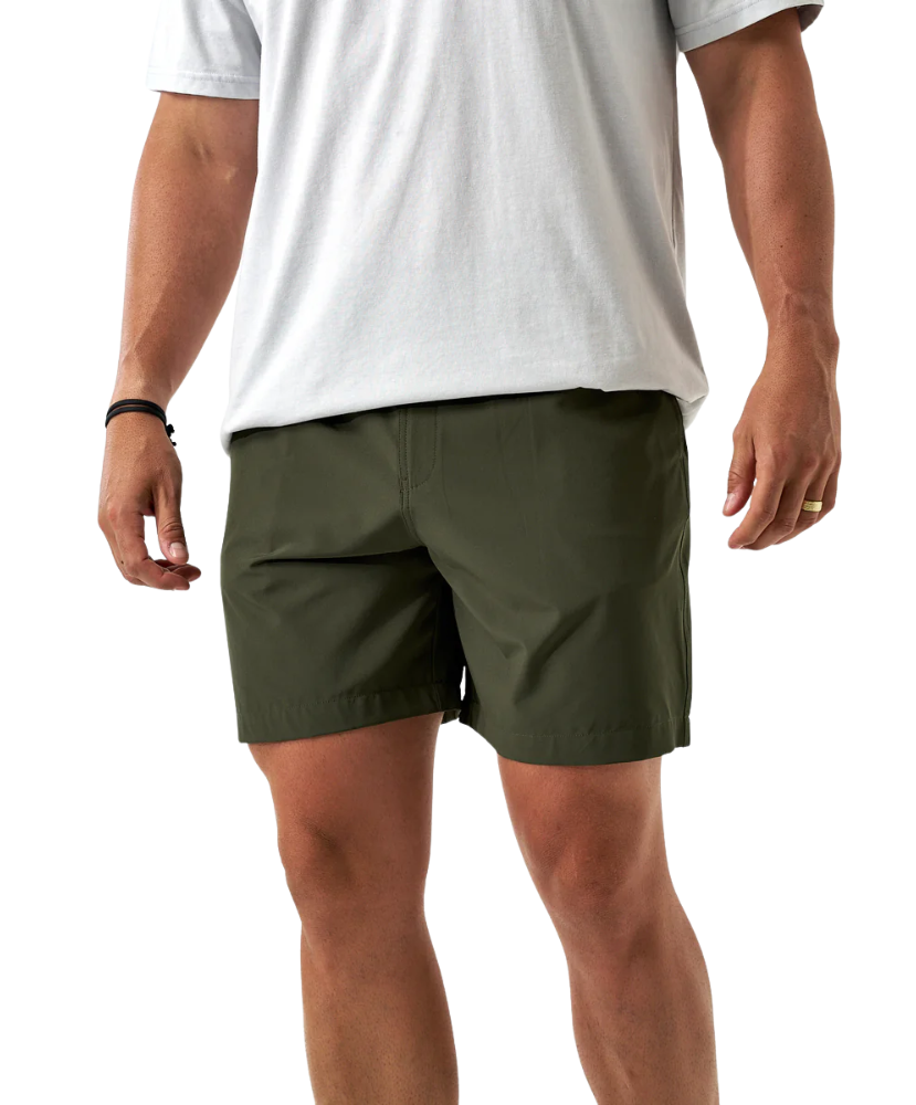 Person wearing green ATHLETIC shorts and a white t-shirt on a white background