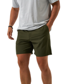 Person wearing green ATHLETIC shorts and a white shirt on a white background