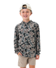 A young boy smiling and wearing a long-sleeve camouflage hoodie with a beige cap and khaki shorts, photographed against a solid white background.