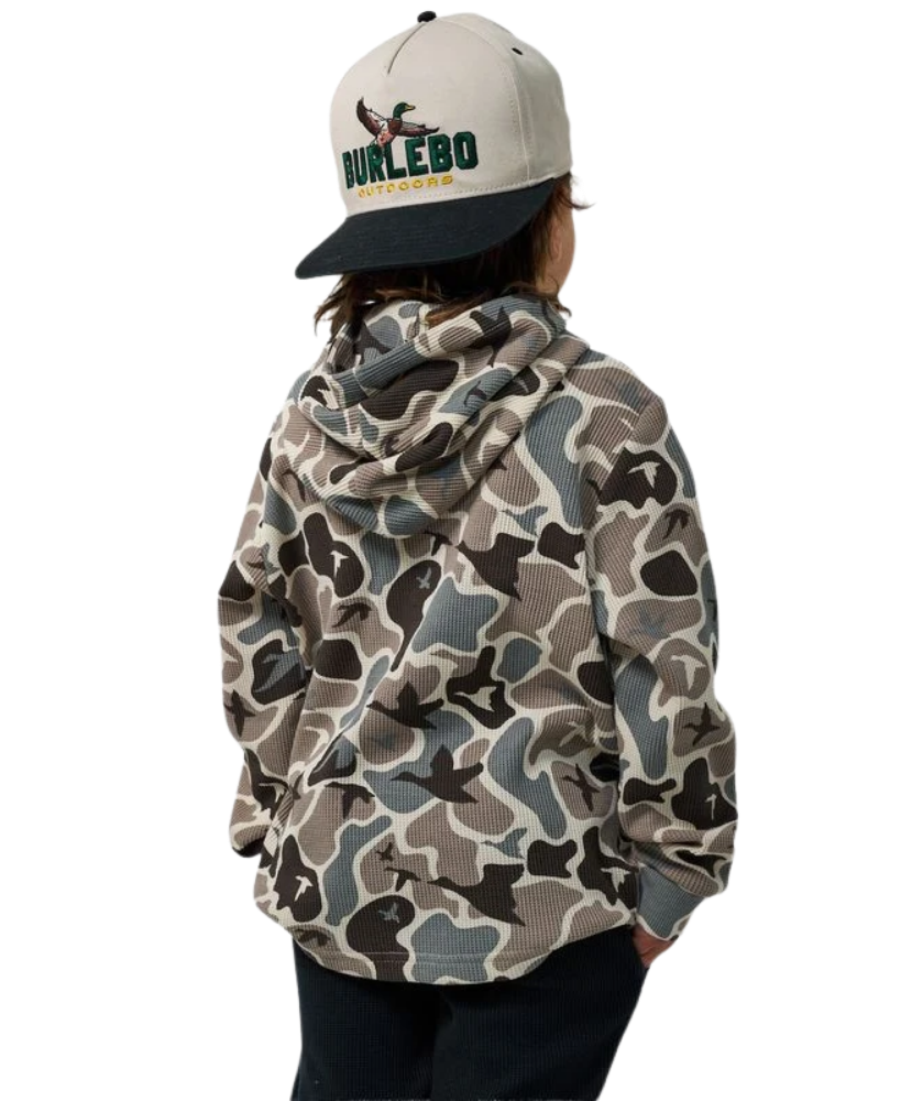 A child shown from the back wearing a camouflage hoodie and a beige and black trucker hat with 'DURLEBO' and a duck logo.