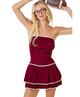 Woman in a maroon cheerleader outfit holding a football against a white background