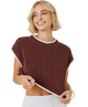 Woman wearing a brown knitted top with white trim on a white background