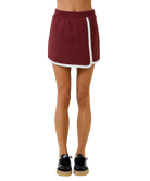 Maroon athletic skirt with white stripe worn by a person on a white background