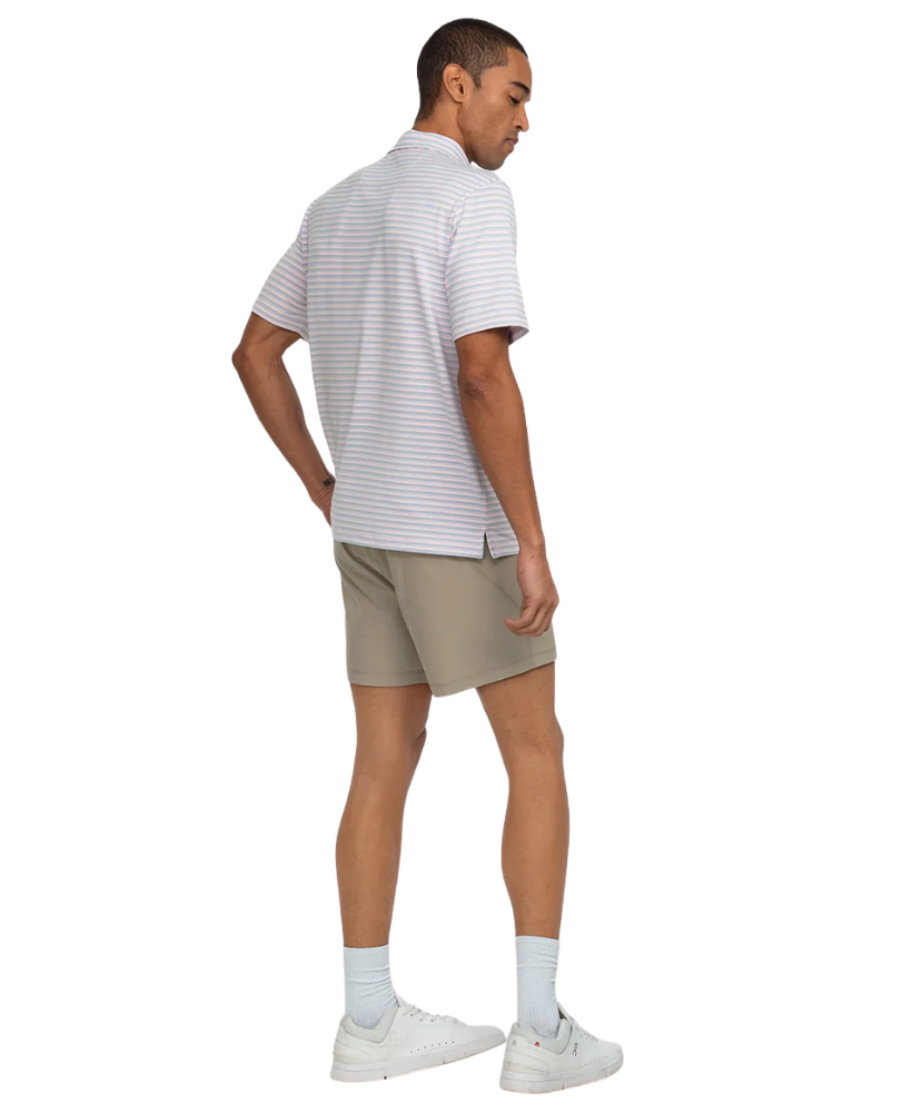 Man wearing a striped polo shirt and beige shorts on a white background