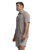 Man wearing a striped polo shirt and beige shorts on a white background