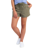 woman wearing olive green shorts on a white background
