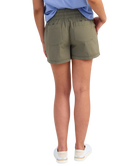 woman wearing olive green shorts on a white background