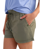 woman wearing olive green shorts on a white background