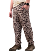 Person wearing camouflage pants on a white background