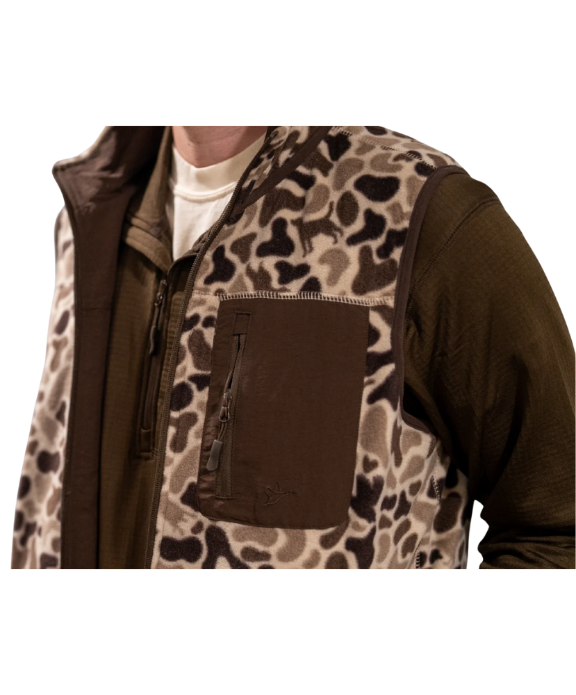 Person wearing a camouflage-patterned vest with a brown background