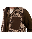 Person wearing a camouflage-patterned vest with a brown background