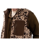 Person wearing a camouflage-patterned vest with a brown background